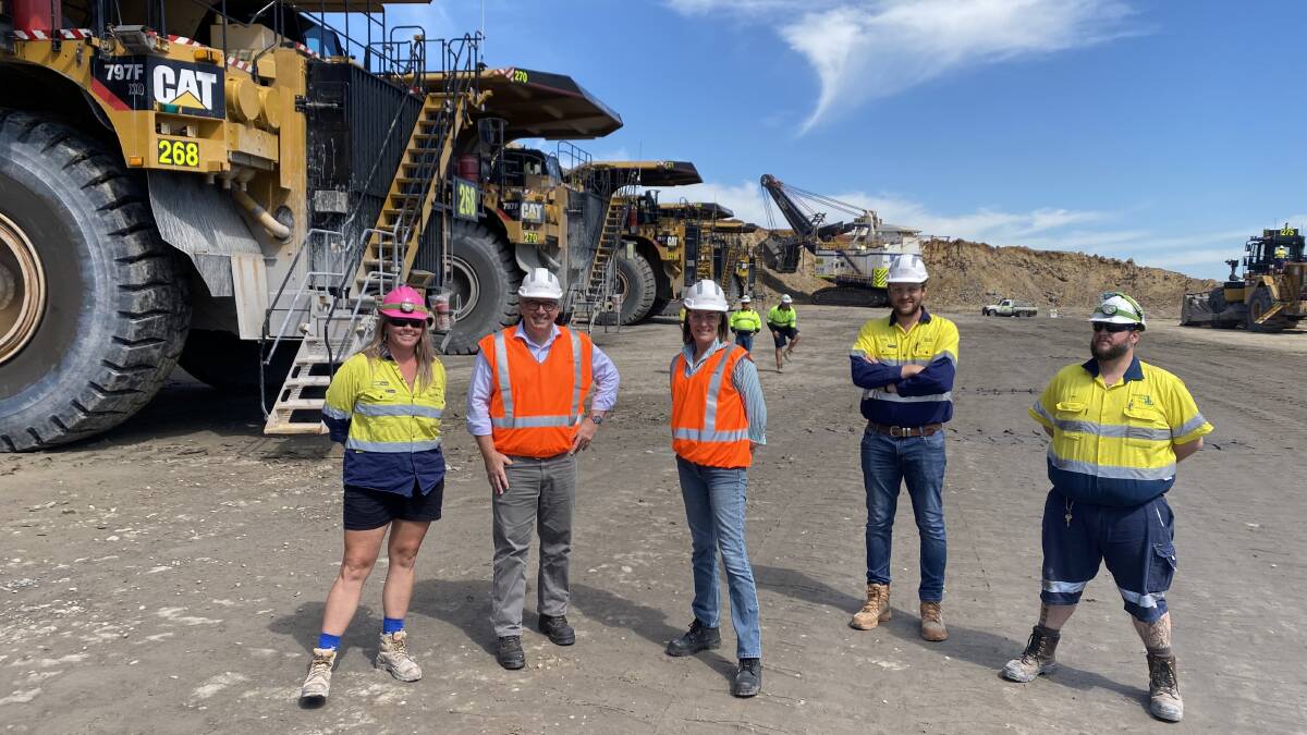 GESTURE: Queensland Liberal MP and federal Minister for Resources, Water and Northern Australia, Keith Pitt, with National Party NSW Senator Perin Davey, flanked by workers at Glencore's Bulga open-cut mine yesterday.