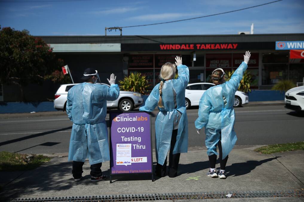 STREET VENDORS: Some of the crew at the Windale pop-up testing clinic yesterday, doing their best to drum up passing trade. Picture: Marina Neil