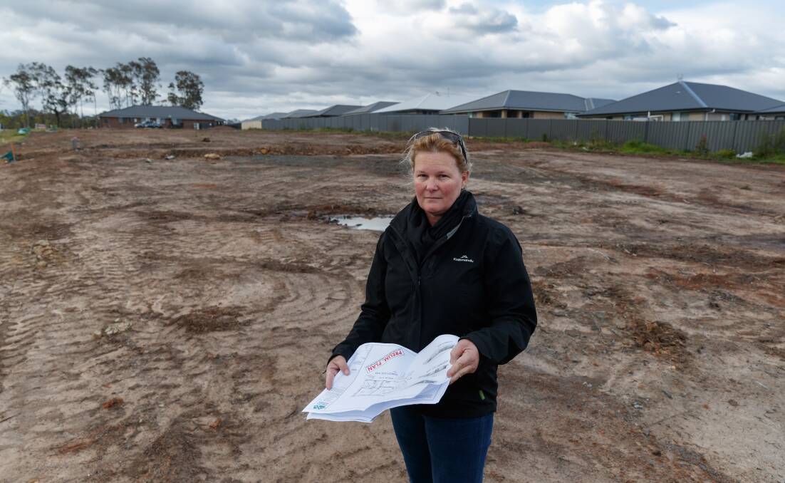 PAPERWORK: Hilton Grugeon employee Karen Hines on a Thornton North site that a client wants to build on with help from a HomeBuilder grant. Picture: Max Mason-Hubers