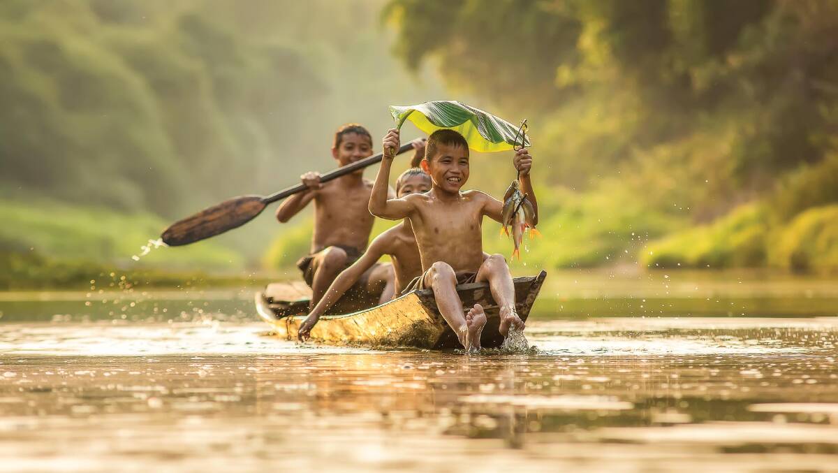 Kids just want to have fun … showing off on the Mekong.