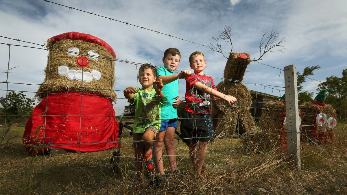 Hay, it's Christmas! The Viola family have decorated their front yard with a hay-bale Santa, Rudolph and elf minions. L-R Ethan 5yrs, James 8yrs and Andrew 7yrs. Picture: MARINA NEIL