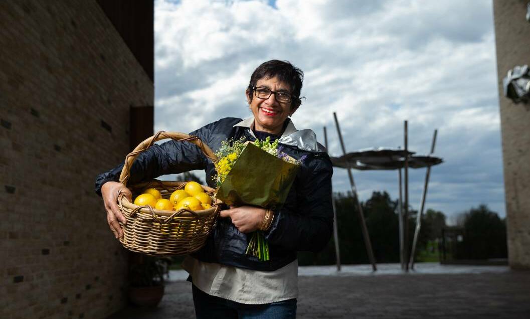 FRESH IS BEST: Slow Food Earth Market Maitland chairwoman Amorelle Dempster in The Levee last year iwth a basket of lemons and a bunch of flowers. Picture: Marina Neil