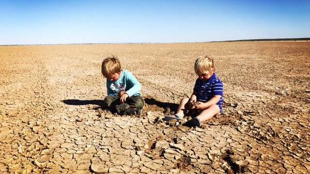 DRY: Finn and Archie Siemer on Yantara Lake, Coally Station north of Broken Hill, that went dry Christmas 2015. Many farms across NSW - not just the far west - are struggling with drought. Picture: Tennille Siemer