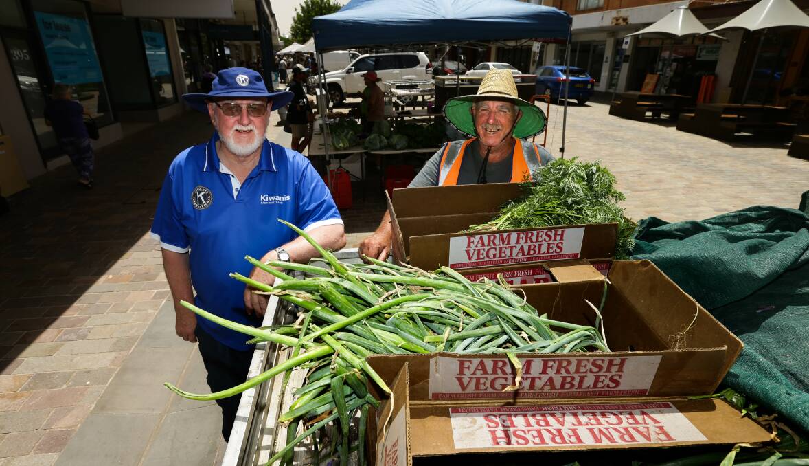 HELPING HAND: Slow Food Hunter Valley volunteers Derek Mitchell and Tony Milburn packing fruit and vegetable boxes for Upper Hunter farmers. Picture: Jonathan Carroll