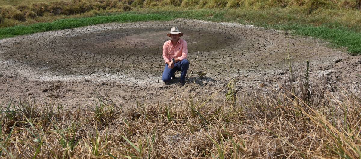 DROUGHT: NSW Primary Industries Minister Niall Blair sits in an empty dam near Stroud during his visit to the Hunter in February. Picture: Belinda-Jane Davis