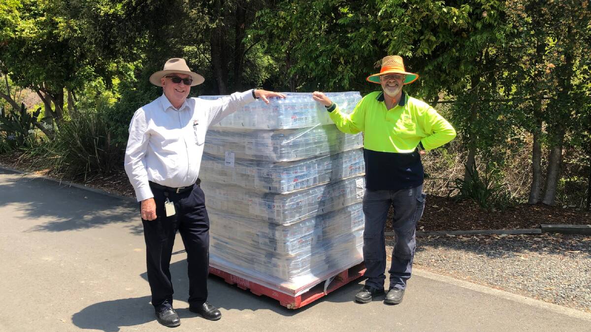 BIG EFFORT: Anglican Care staff with the water that will be taken to Murrurundi on Thursday. 
