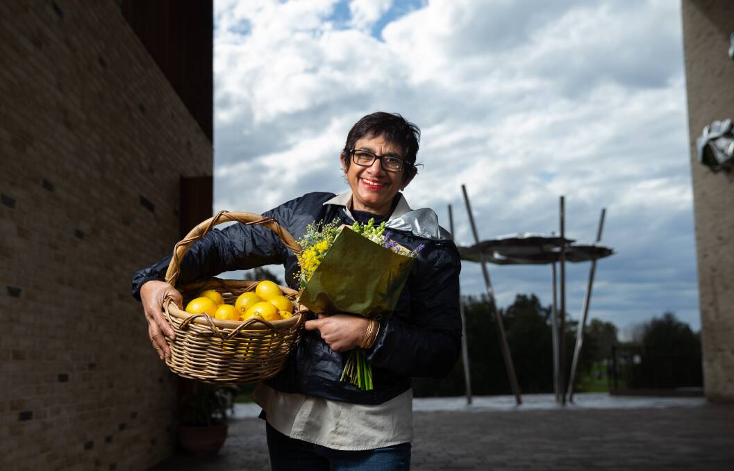 IN FOCUS: Slow Food Earth Market chairwoman Amorelle Dempster with a basket full of lemons and a bunch of flowers from the Slow Food Earth Market Maitland in The Levee. Picture: Marina Neil