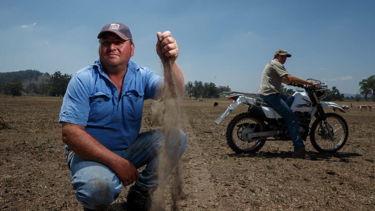 DUST: Dairy farmer Jamie Marquet, left, at his farm at Wallarobba in February. Picture: Max Mason-Hubers