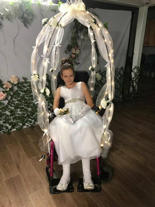 BELLE OF THE BALL: Hayley Quick in her carriage the community helped make possible.