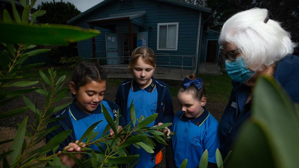 INTO THE PAST: Maitland-Rutherford Girl Guides Sophia Rabonu, Taya Lieben and Avah Smith with district manager Jill Norburn in the garden in July last year. Picture: Marina Neil