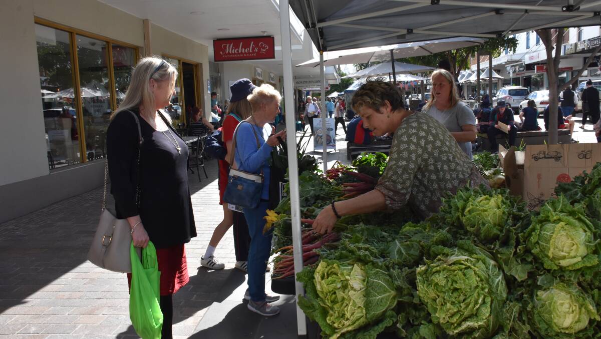 LOCAL FOOD: Producers sell local food at the Slow Food Earth Market in The Levee.