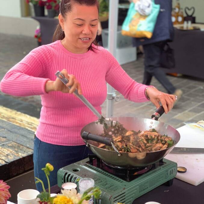 Aberglasslyn grower Felicia Nguyen cooks her mushroom stir fry at the Slow Food Earth Market Maitland. Picture supplied 