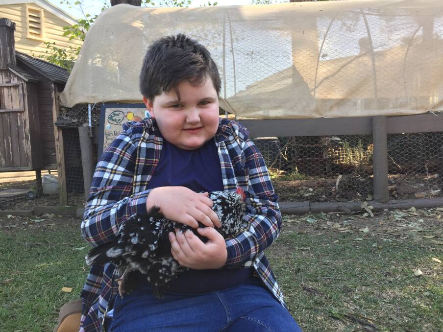 GENEROUS: Six-year-old Max Hayes with one of the chooks at Tenambit Public School. He is supporting drought-stricken farmers. Picture: Belinda-Jane Davis