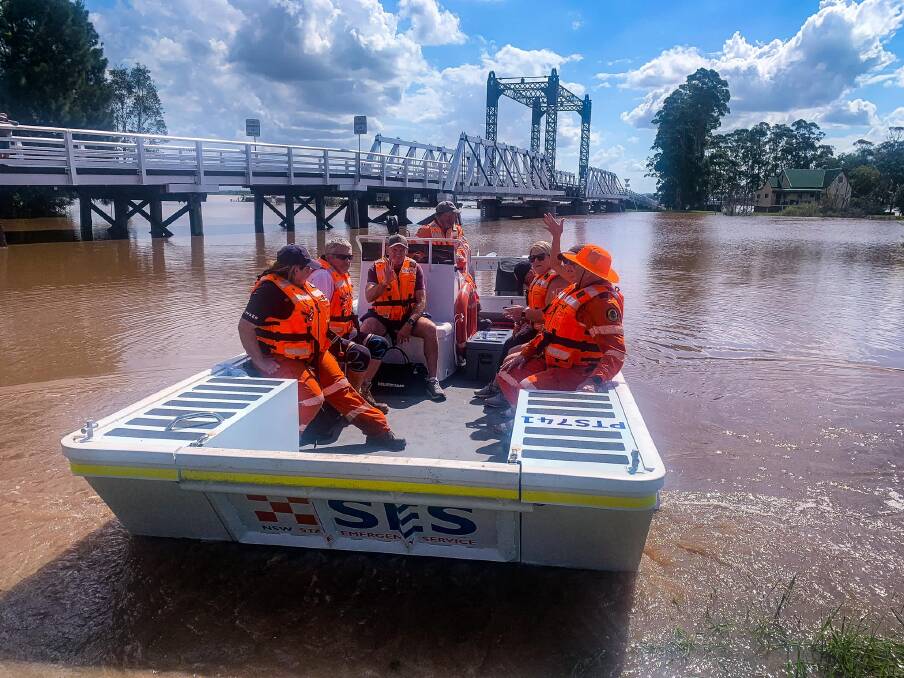 ON THE WATER: Residents and Port Stephens SES Unit volunteers on a flood boat at Hinton. Picture: Port Stephens SES Unit.