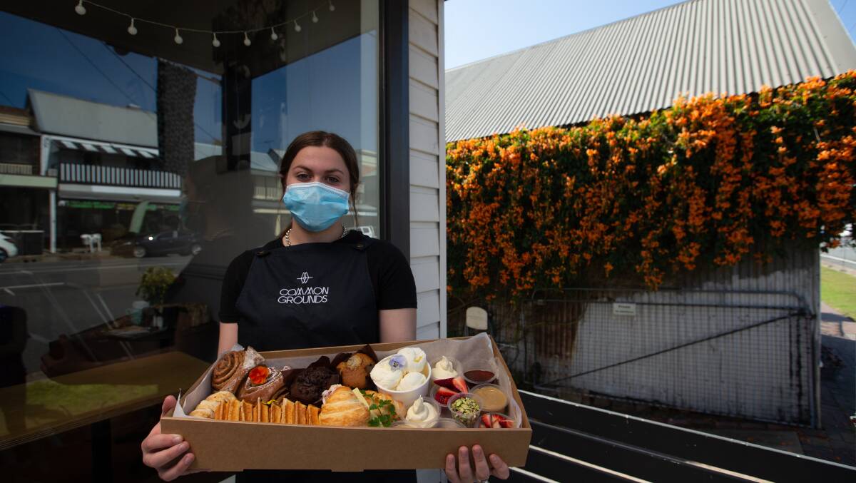 TREATS FOR DAD: Common Grounds team member Emily Brosie holds the large Father's Day box outside the cafe. Picture: Marina Neil