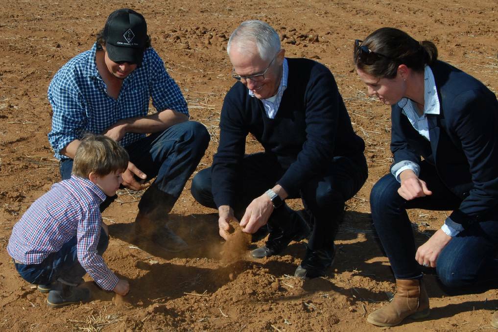 DROUGHT: Prime Minister Malcolm Turnbull (centre) with farmer Phillip Miles (left), his wife Ashley and their son Jack (front) during a visit to Strathmore Farm in Trangie on Monday.