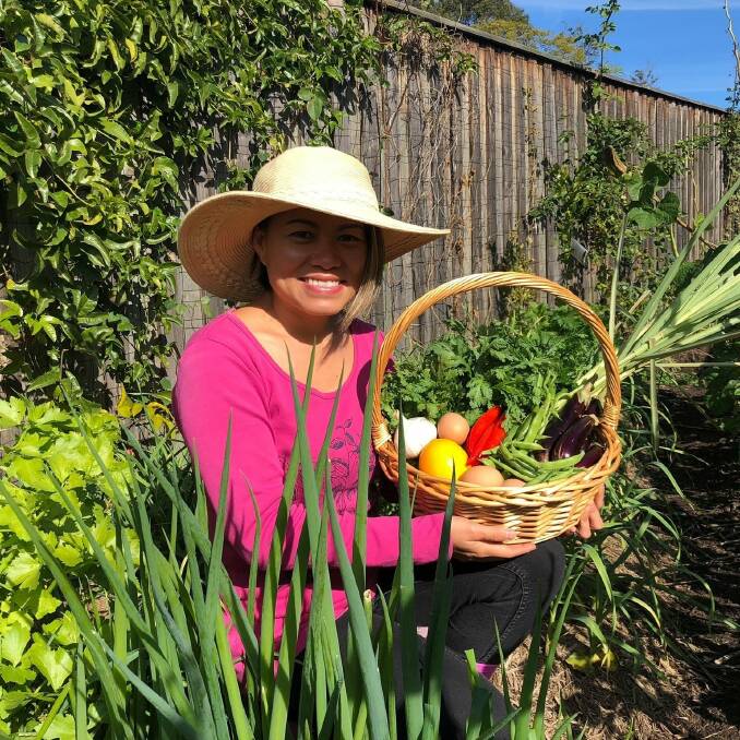 HAPPY HARVESTING: Felicia Nguyen in her Asian suburban garden. Picture: Earth Market Maitland Facebook page