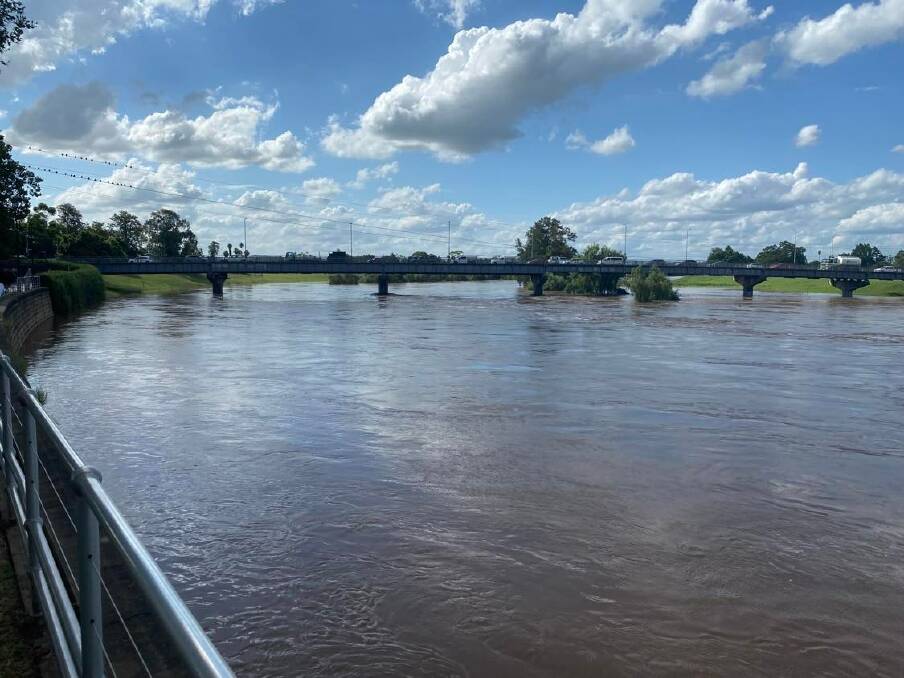 SWOLLEN: The Hunter River at the Belmore Bridge in Maitland on Friday afternoon. Picture: Michael Hartshorn.