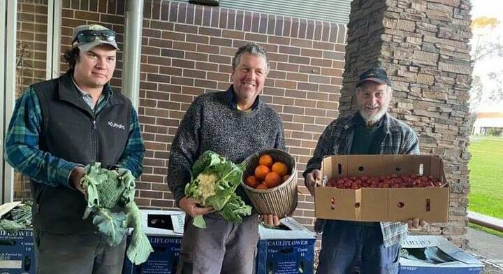 FRESH FOCUS: Farmers Liam Dennis, Matthew Dennis and Austin Breiner with some of the produce that was sent to residents stranded at Gillieston Heights. 