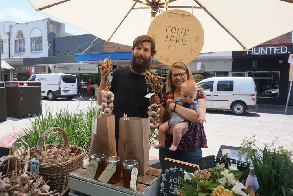 GARLIC WIN: Farmers Tom Christie and Dominique Northam with their son Jude, their garlic and other products at the Slow Food Earth Market Maitland. 