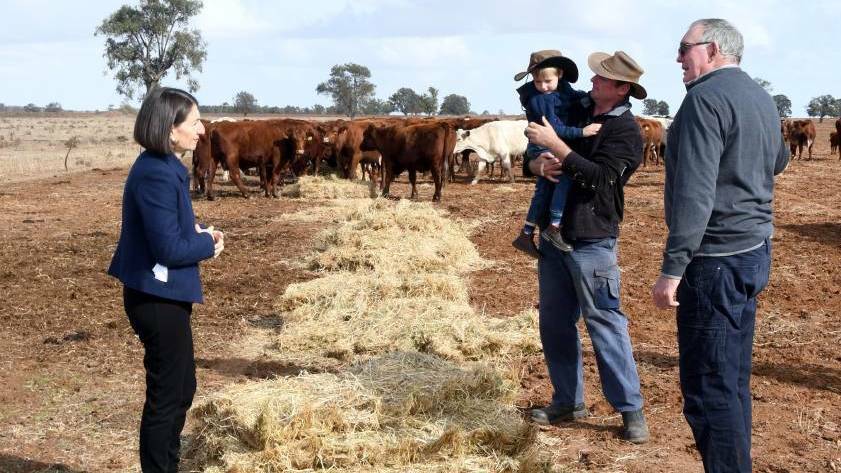 DROUGHT ANNOUNCEMENT: NSW Premier Gladys Berejiklian with Edward, Brad and Dennis Cox at a farm in Dubbo in June 2018. Picture: Belinda Soole