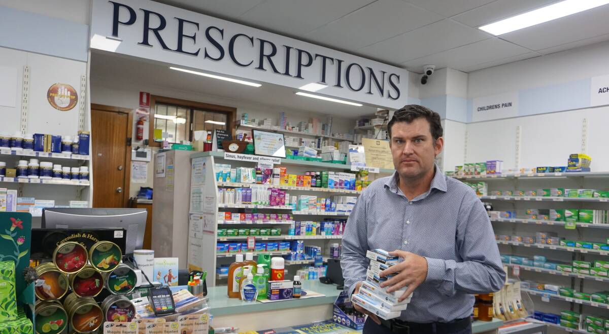 VIRUS: Morpeth Pharmacist Michael White with some of the items that are in demand.