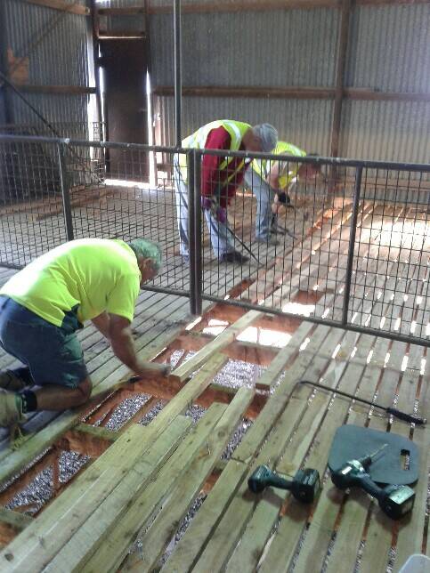 HELPING HAND: Rural Aid Farm Rescue volunteers replace the floor in a large shearing shed.