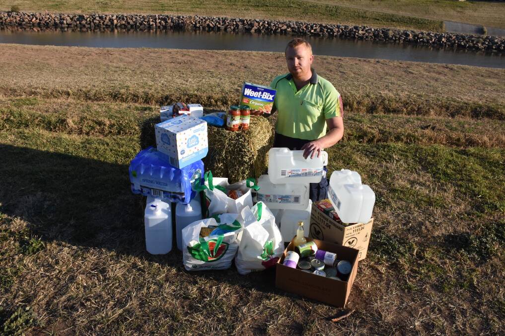 FOR THE FARMERS: Issac Delalande with some of the supplies that were delivered to drought-stricken Coonabarabran farmers over the weekend. Picture: Belinda-Jane Davis