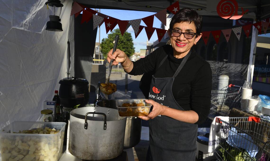COOKING: Slow Food Hunter Valley leader Amorelle Dempster with a serving of beef and potato curry at Maitland produce market. Picture: Belinda-Jane Davis