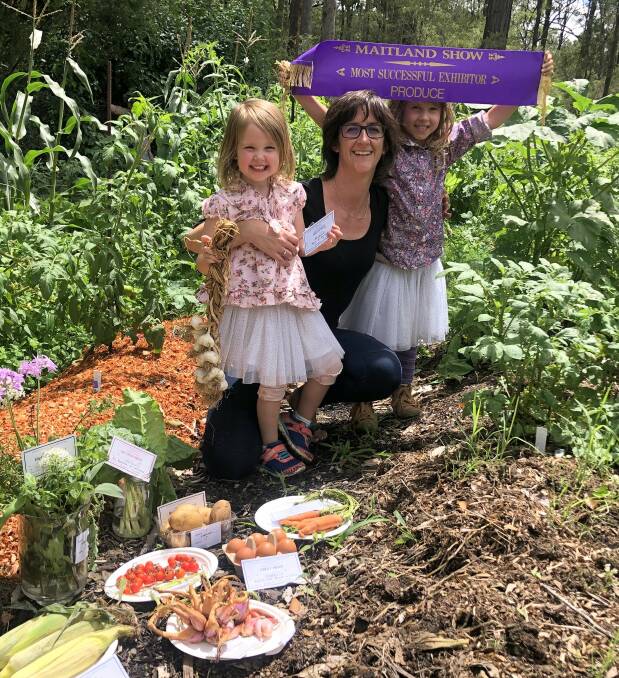 SHOW WIN: Maitland Show's Most Successful Exhibitor in Produce Section for 2021 was Jacqui Purcell (centre), pictured here with her two daughters. Picture: supplied