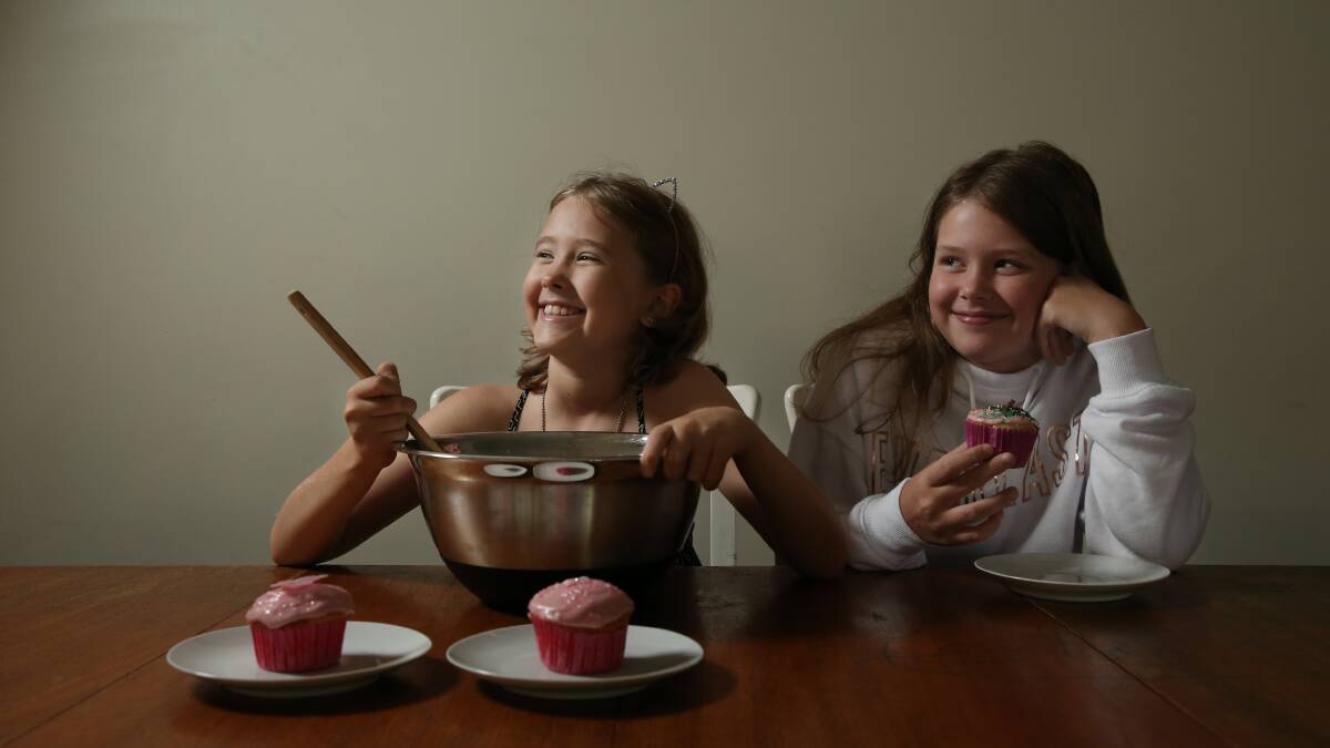 EXCITING PROJECT: Ruby Holdsworth with her sister Sarah, 10, taste testing a test batch of cupcakes.
