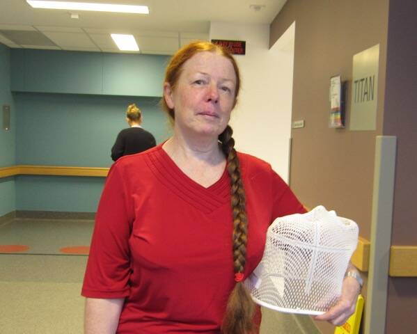 SURVIVOR: Bev Snedden with the face mask she wore during radiotherapy at the Mater Hospital in Newcastle.