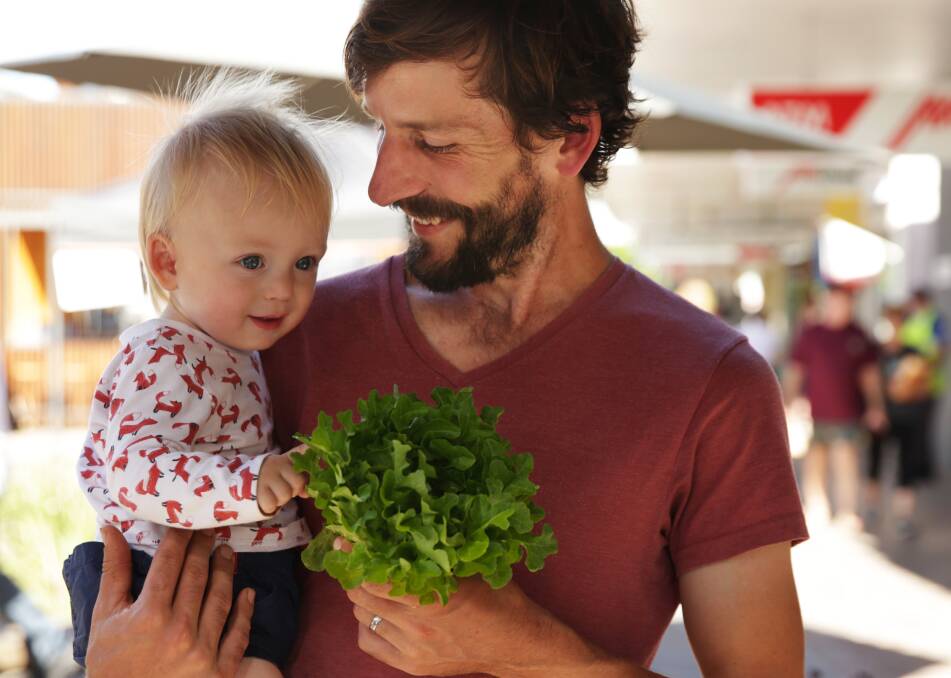FRESH FOOD REVOLUTION: Farmer Tom Christie with son Jude at the Slow Food Earth Market Maitland. Picture: Simone De Peak