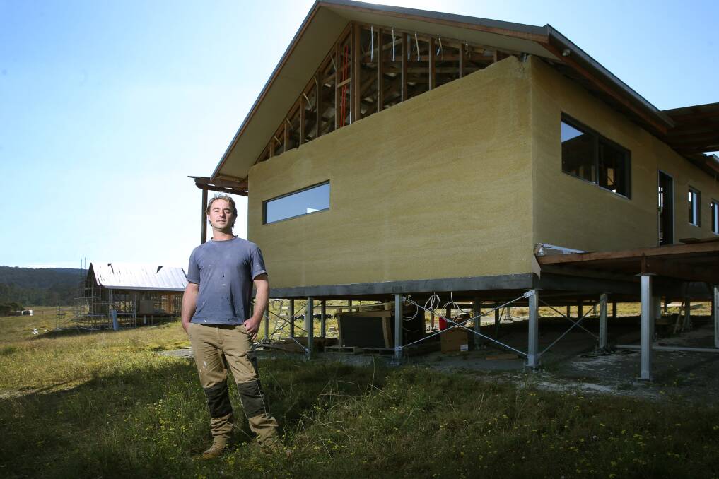 Hemp builder Shane Hannan, in front of the first house at Shepherds Ground that he has finished with the hempcrete. Picture: Marina Neil