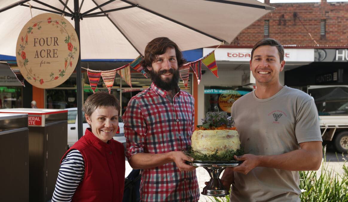 CELEBRATION: Young farmers Lisa Kalokerinos, Tom Christie and Jesse Clark with an orange birthday cake at the Slow Food Earth Market Maitland on Thursday. 