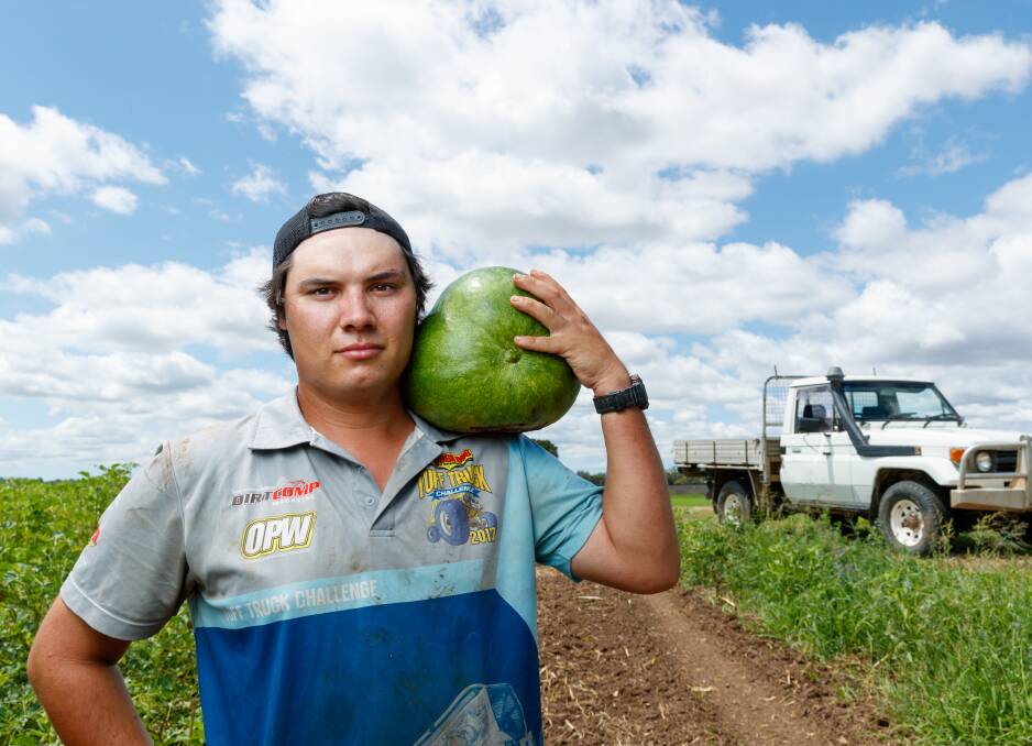 Farmer Liam Dennis, of Nebo Farm, holds a watermelon. Picture by Max Mason-Hubers 