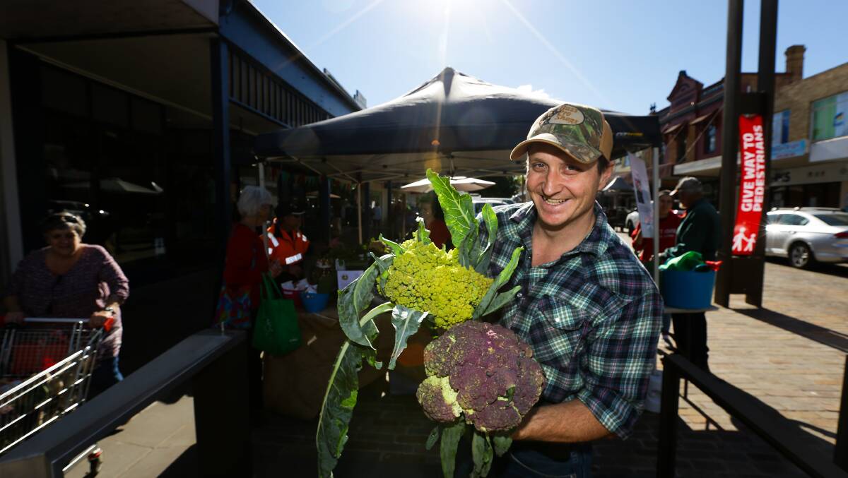GOOD FOOD: Austin Breiner's son Kieran with a Romanesco Broccoli, top, and a purple cauliflower. Picture: Jonathan Carroll. 