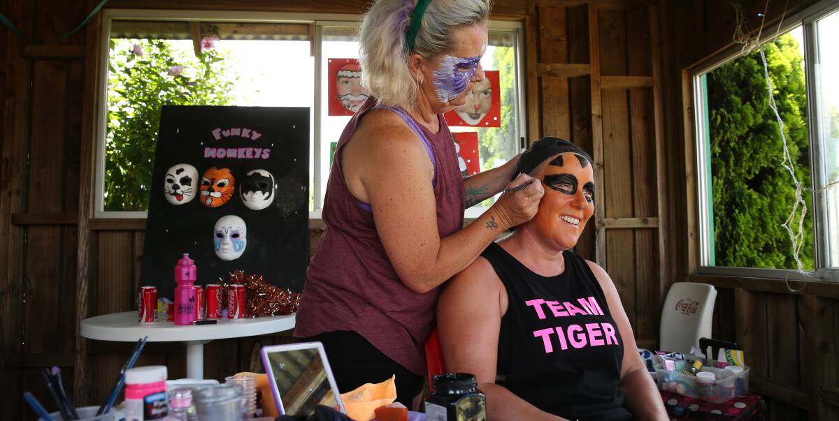 FUNDRAISING: Cancer patient Linda Bullent having her face painted by Mel Edwards at the fun day she held in Raworth last month. Picture: Max Mason-Hubers