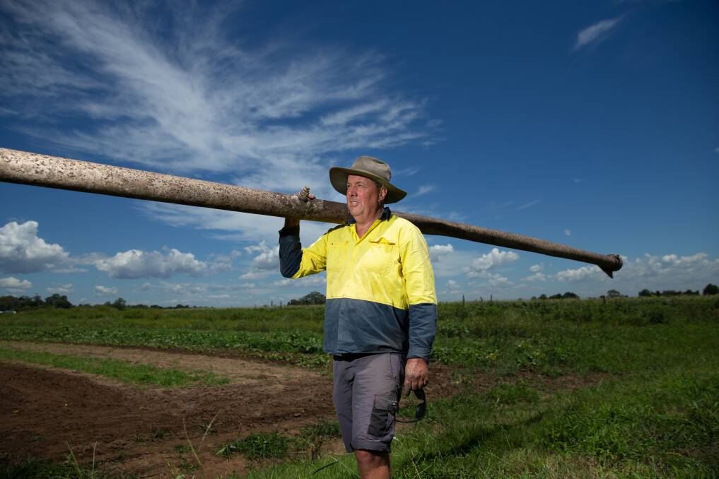 DESPAIR: Matthew Dennis holds an irrigation pipe at his East Maitland farm. Picture: Marina Neil