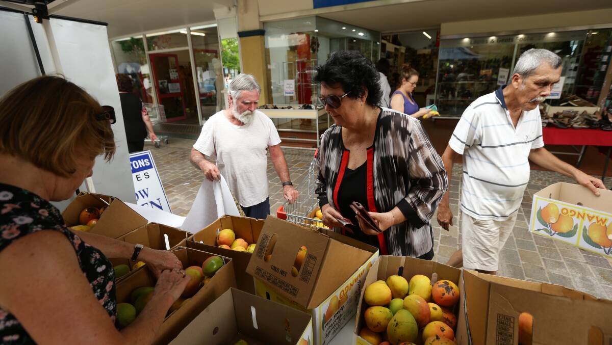 MANGOES IN DEMAND: Shoppers buying mangoes in The Levee. Picture: Jonathan Carroll.