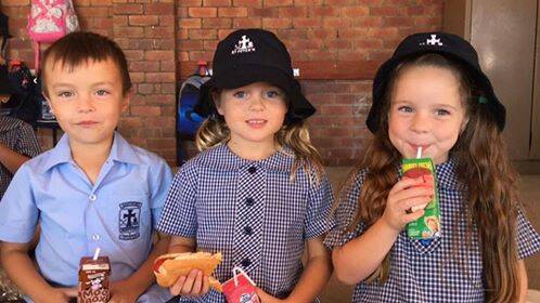HELPING: St Peter's Primary School Stockton students Beau Kwok, Bette Crampton and Charlotte Jeans were among those who supported Hunter farmers. 