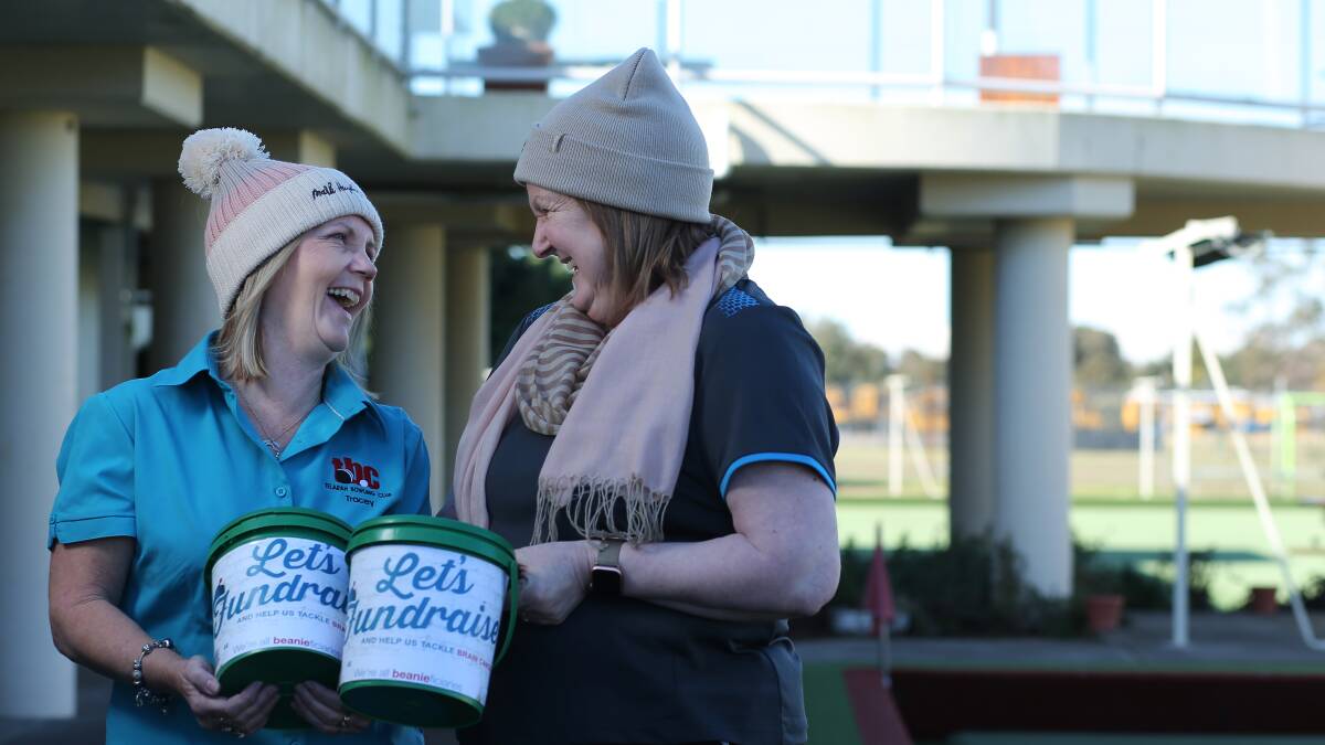 HELPING: Telarah Bowling Club secretary manager Tracey Peterson and Telarah Bowling Club supervisor Janene Wennen with Mark Hughes Foundation Beanies. Picture: Simone De Peak 