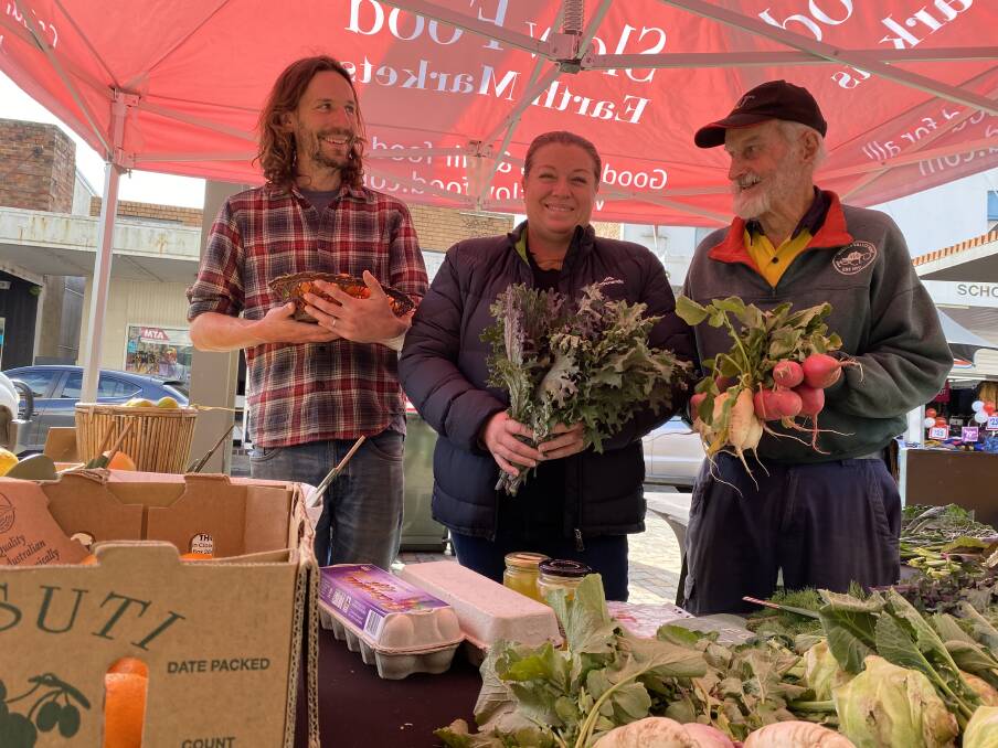PARTY TIME: Farmers Tom Christie, Crissy Rowcliff and Austin Breiner with some of their produce at the Slow Food Earth Market Maitland in The Levee in July.
