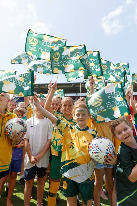 FLAG BEARERS: Young Newcastle fans show their support for the Matildas.
