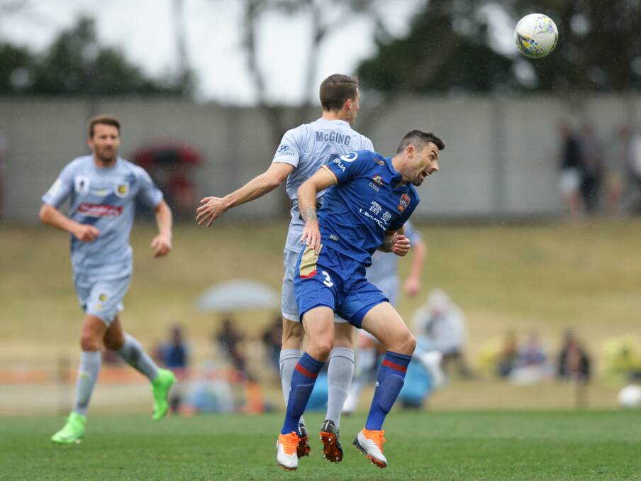 HEADS UP: Jason Hoffman competes for possession in the Jets' 2-all draw with the Central Coast Mariners at Maitland Sportsground on Saturday. Picture: Jonathan Carroll 