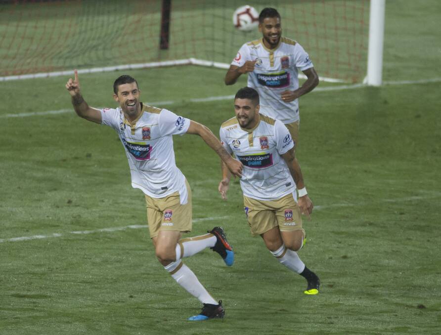 ON TARGET: Jason Hoffman (left) celebrates with Dimi Petratos and Ronny Vargas after scoring the Jets' second goal against Western Sydney on Friday night. Picture: AAP