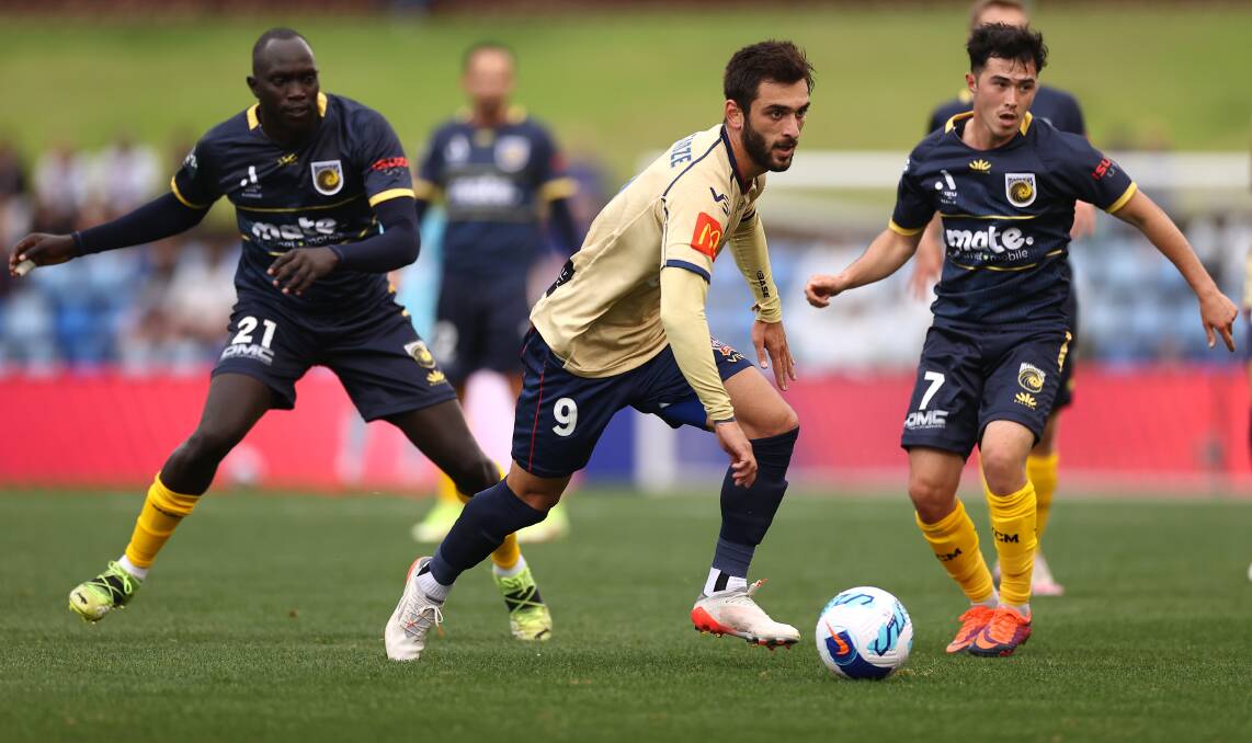 STRONG: Jets striker Beqa Mikeltadze drives the ball towards goal at McDonald Jones Stadium. The Georgian was denied by the post in the 2-1 loss to the Mariners. Picture: Getty Images