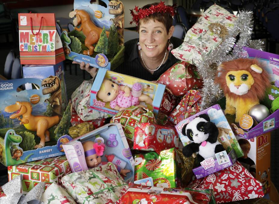 TOY-RIFFIC: Lorn Park Bowls Sports & Recreation Club secretary-manager Heather Maguire in amongst the pile of donated toys. Picture: Waide Maguire