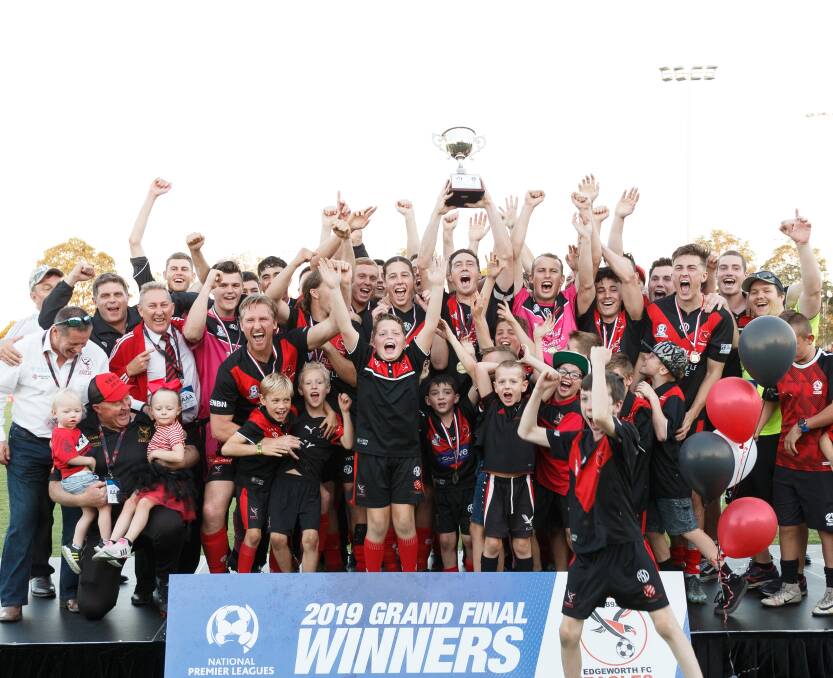 PARTY TIME: The Edgeworth Eagles and their supporters celebrate on stage after winning the Northern NSW NPL grand final 2-0 over Maitland on Sunday at Magic Park. It was the club's fifth consecutive grand final appearance but first win since 2016. Picture: Max Mason-Hubers