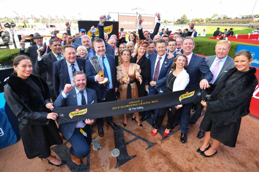 PARTY TIME: The connections of Chief Ironside, with Australian Bloodstock director Luke Murrell holding the Crystal Mile trophy, celebrate their victory at Moonee Valley on Saturday. Picture: Getty Images